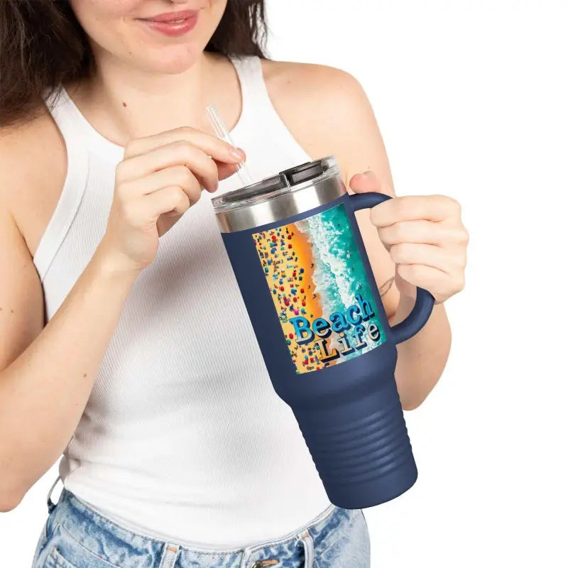 Navy blue travel mug featuring an insulated design and a beach scene