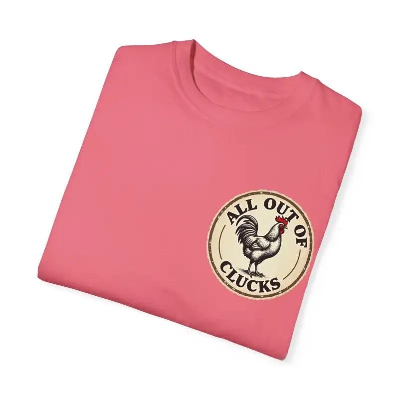 Folded pink t-shirt featuring a chicken graphic from All Out of Clucks Mens Casual Collection