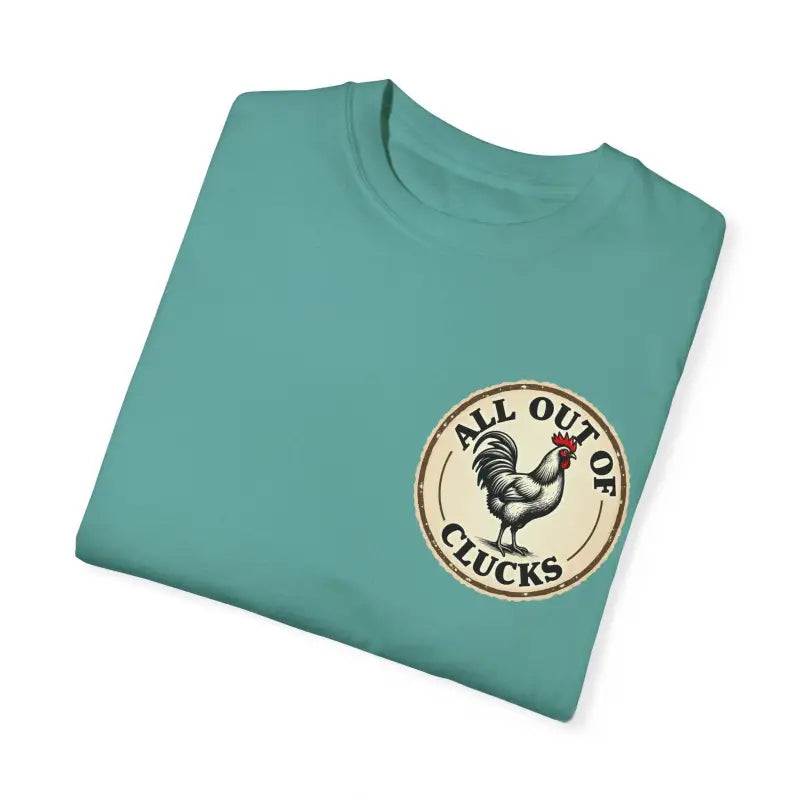 Folded teal t-shirt featuring chicken graphic from All Out of Clucks Mens Casual Collection