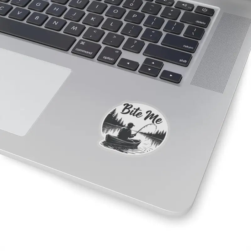Laptop adorned with Bite Me Fishing In Canoe Sticker showcasing fishing-themed decor
