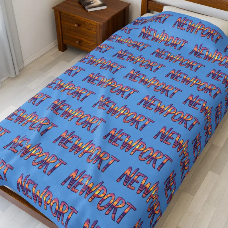 Blue bedspread featuring Newport text pattern, ideal for stylish home decor