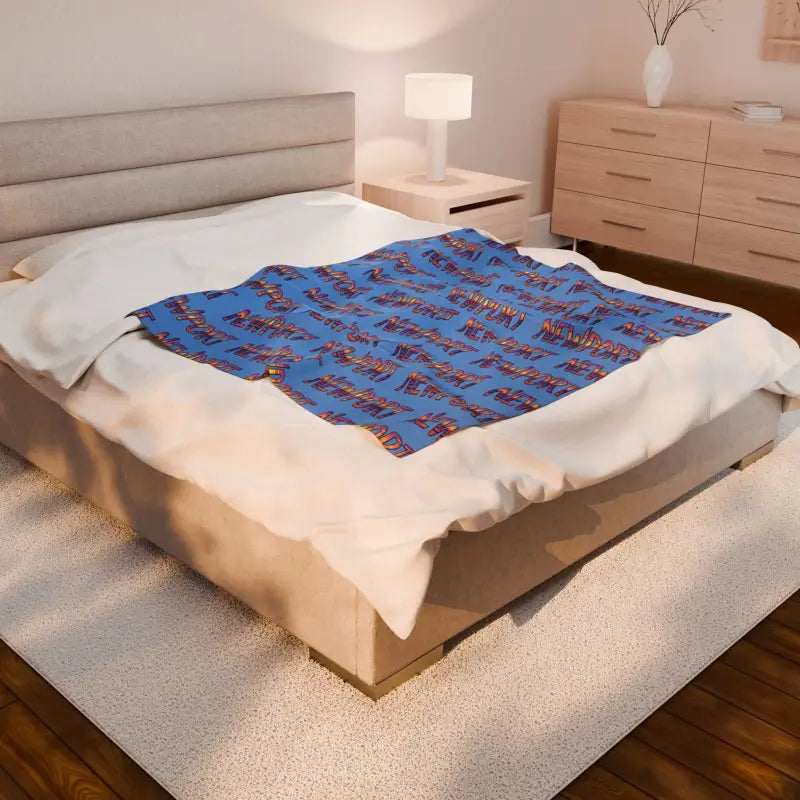 Bed featuring a Blue Blanket with Newport Text Pattern in an elegant setting