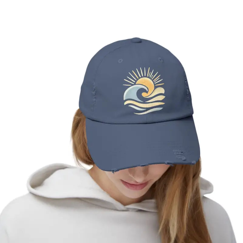 Distressed blue cap featuring a sun and wave design for ocean enthusiasts