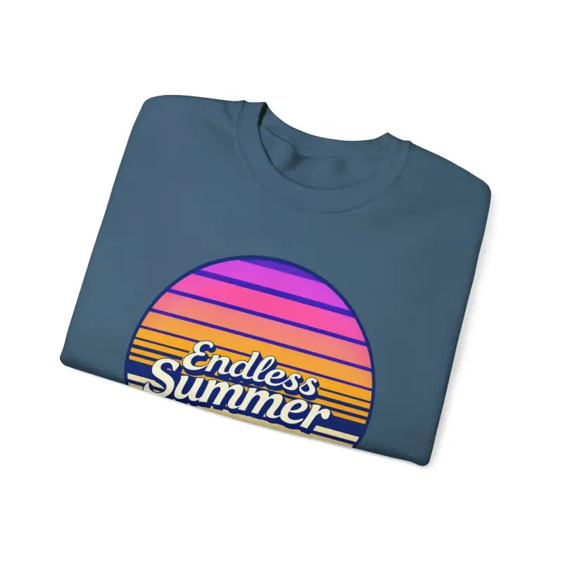 Folded blue t-shirt featuring sunset graphic from Endless Summer crewneck sweatshirt