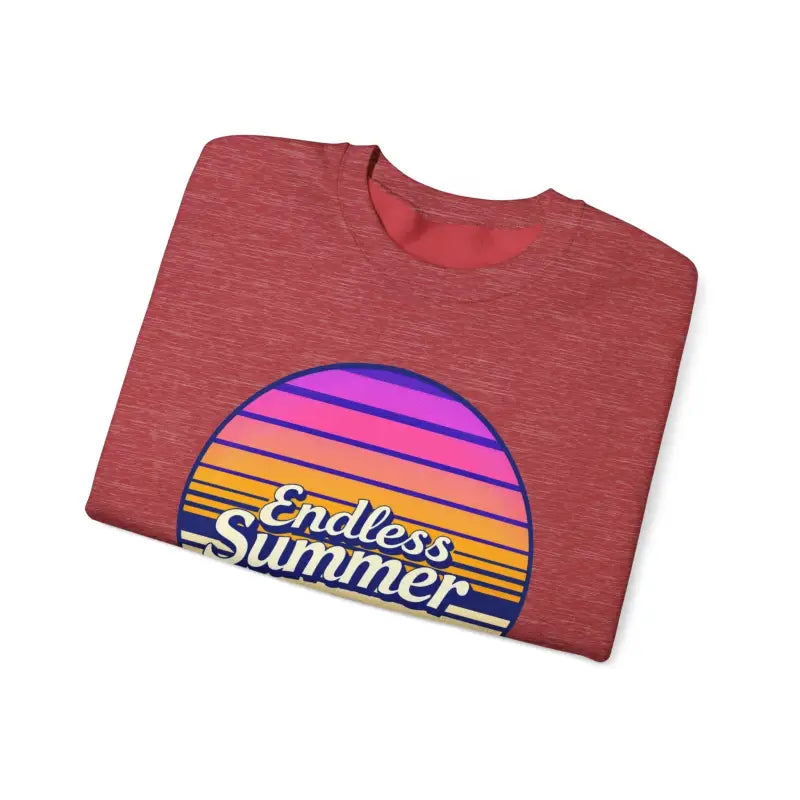Folded red t-shirt featuring sunset graphic from Endless Summer unisex crewneck sweatshirt