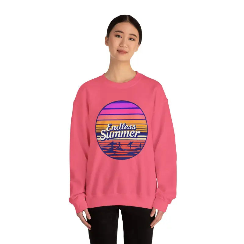 Pink sweatshirt featuring a sunset graphic in a retro design for a relaxed vibe