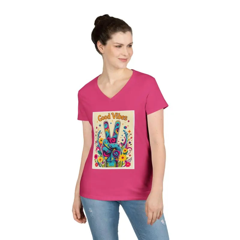 Woman’s pink v-neck t-shirt featuring Good Vibes peace and positivity graphic
