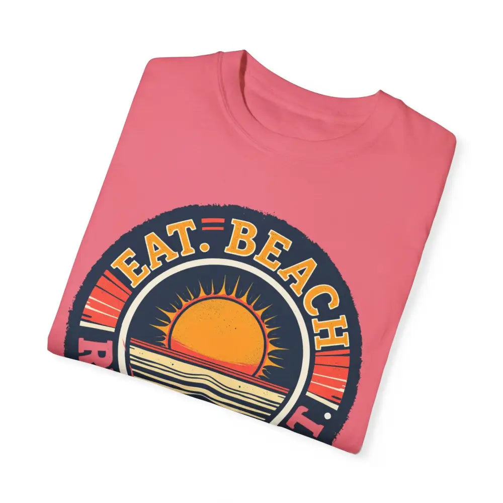Folded pink Island Reef tee with beach graphic, perfect for relaxed summer vibes