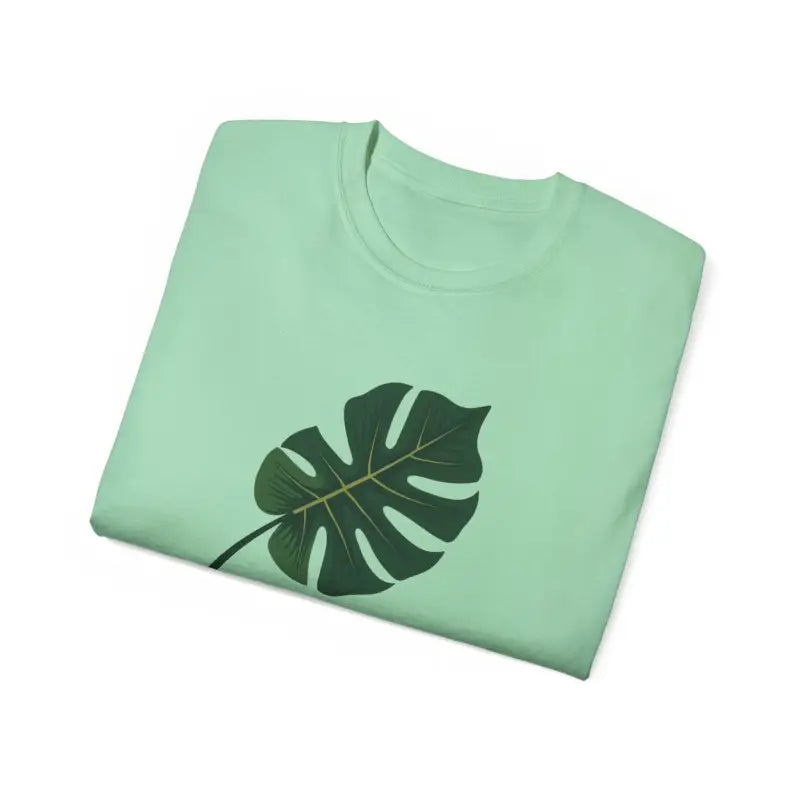 Mint green t-shirt featuring a Monstera leaf design for plant enthusiasts
