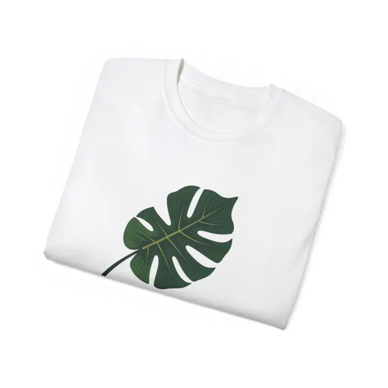 Folded white t-shirt with green Monstera leaf design for Lavender Plant Mom theme