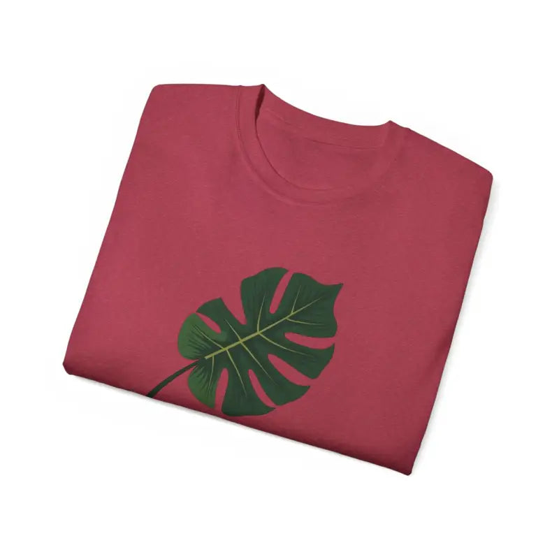 Folded red t-shirt with green Monstera leaf design for Lavender Plant Mom
