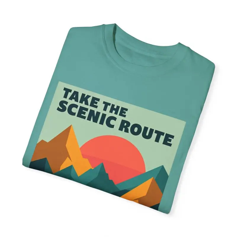 Folded teal Unisex Mountain Graphic Hiking T Shirt featuring a mountain design