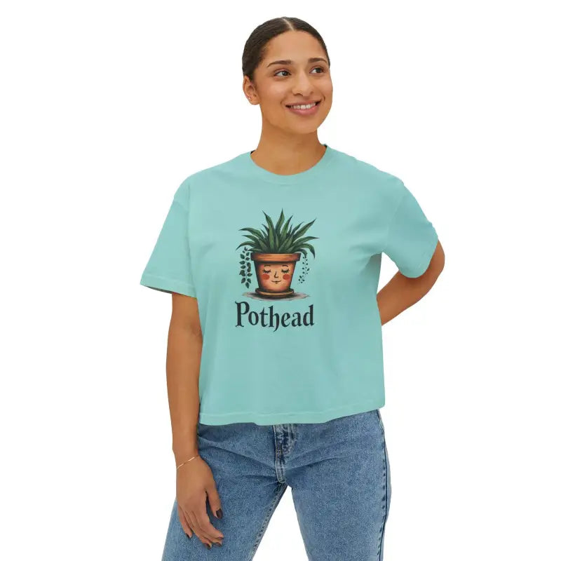 Woman in light blue boxy t-shirt featuring a cute planter graphic design