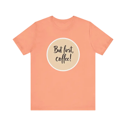 Peach-colored Coffee Lover Tee featuring But first, coffee! design for unisex wear