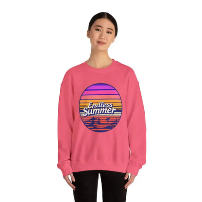 Pink sweatshirt featuring a sunset graphic in a retro design for a relaxed vibe