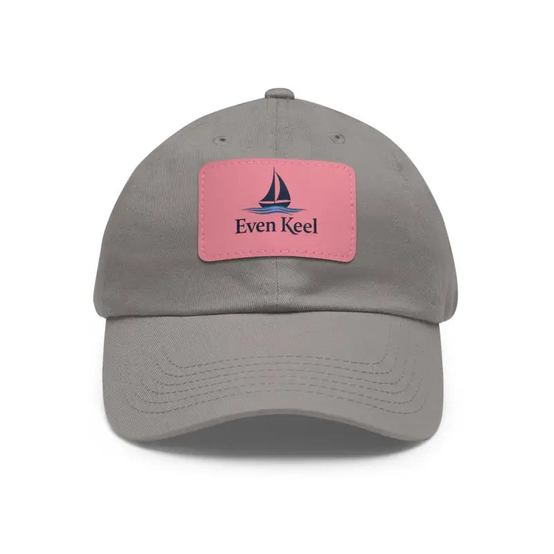 Gray baseball cap featuring a pink patch from the Even Keel Signature Dad Hat collection