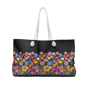 Black tote bag featuring a colorful floral print from the Floral Weekender Bag collection
