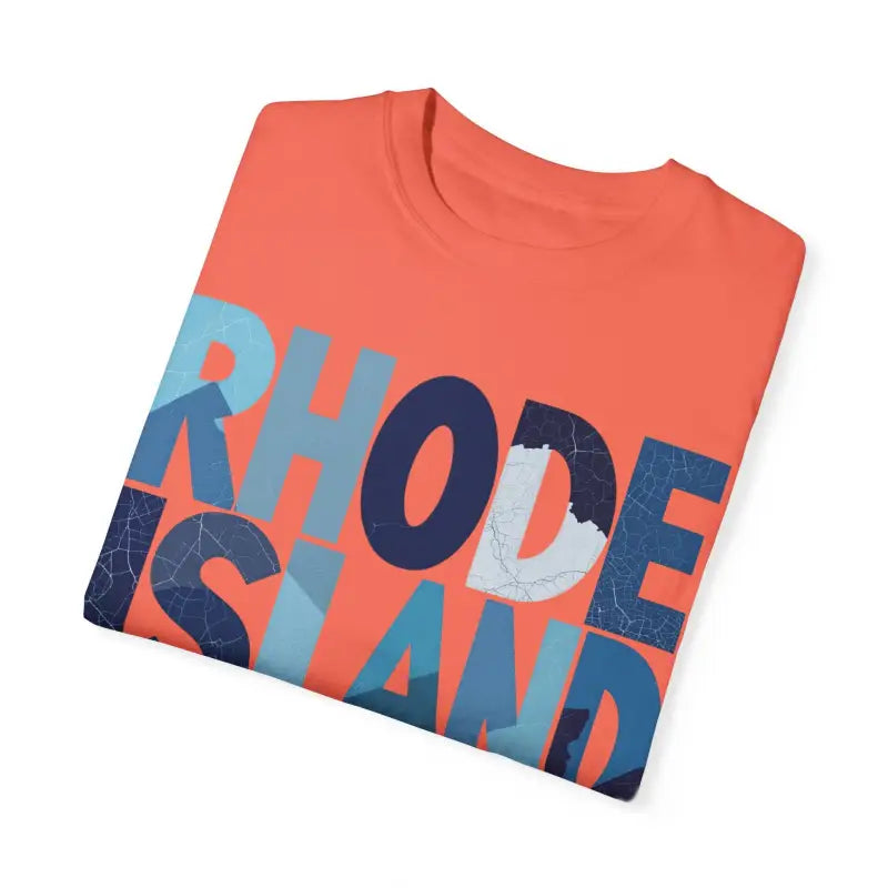 Folded coral t-shirt featuring Rhode Island text in unisex garment dyed design