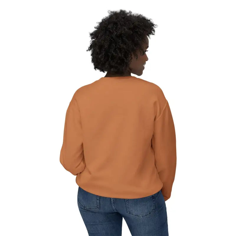 Woman in orange sweatshirt and jeans wearing Rhody Unisex Lightweight Crewneck Sweatshirt