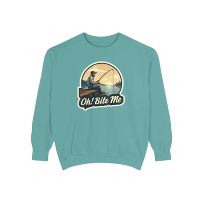 Teal sweatshirt featuring fishing graphic from Sitting on the Dock Bite Me collection