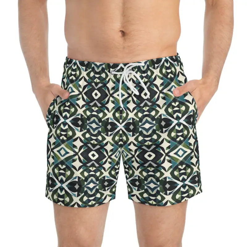 Patterned men’s swim trunks with geometric greens and blacks for summer beachwear