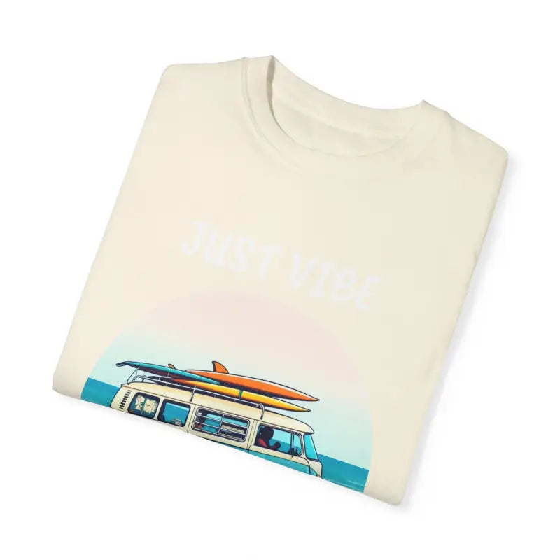 Folded cream-colored t-shirt with van and surfboards graphic for summer vibes
